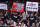 Fans hold signs about Hong Kong during the second half of an NBA basketball game between the Houston Rockets and the Milwaukee Bucks, Thursday, Oct. 24, 2019, in Houston. (AP Photo/Eric Christian Smith)