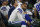 Dallas Cowboys quarterback Dak Prescott (4) and offensive coordinator Kellen Moore, rear, sit on the bench late in the second half of an NFL football game against the Buffalo Bills in Arlington, Texas, Thursday, Nov. 28, 2019. (AP Photo/Ron Jenkins)