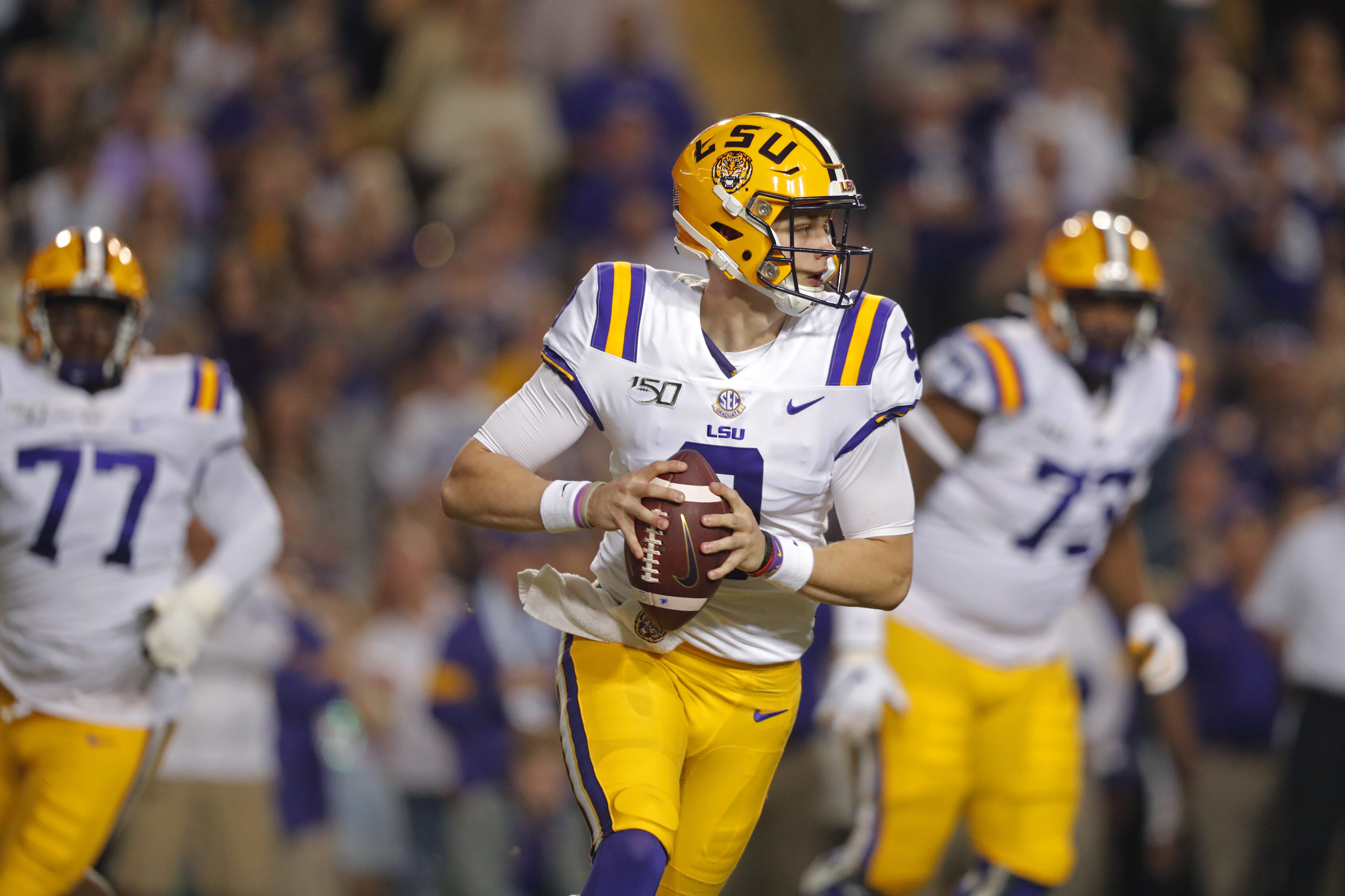 LSU quarterback Joe Burrow (9) scrambles in the first half of an NCAA college football game against Texas A&M in Baton Rouge, La., Saturday, Nov. 30, 2019. (AP Photo/Gerald Herbert)