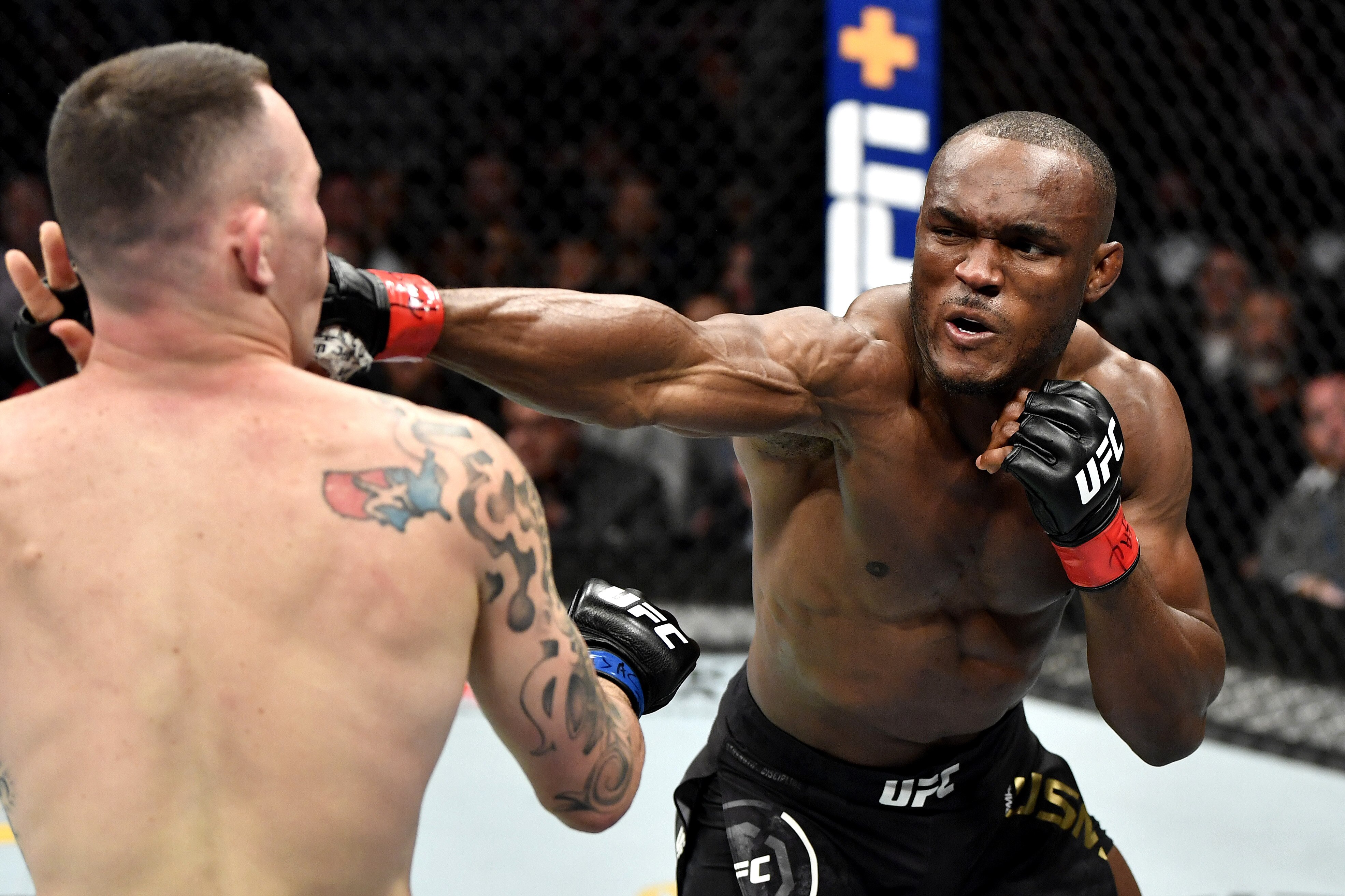 LAS VEGAS, NEVADA - DECEMBER 14: (R-L) Kamaru Usman of Nigeria strikes Colby Covington in their UFC welterweight championship bout during the UFC 245 event at T-Mobile Arena on December 14, 2019 in Las Vegas, Nevada. (Photo by Jeff Bottari/Zuffa LLC via Getty Images)