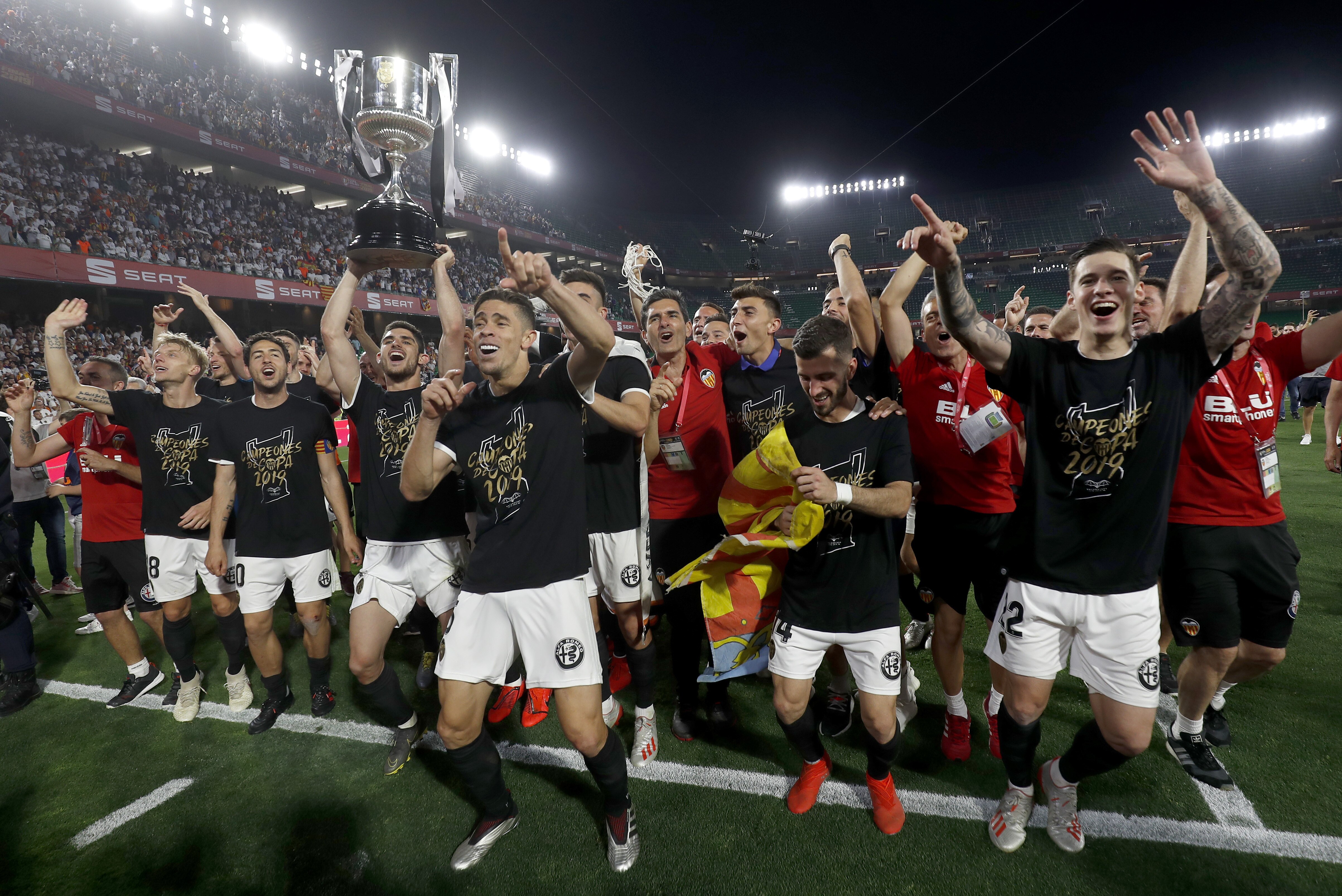 Valencia players celebrate with the trophy after winning the Copa del Rey soccer match final between Valencia CF and FC Barcelona at the Benito Villamarin stadium in Seville, Spain, Saturday. 25, 2019. (AP Photo/Miguel Morenatti)