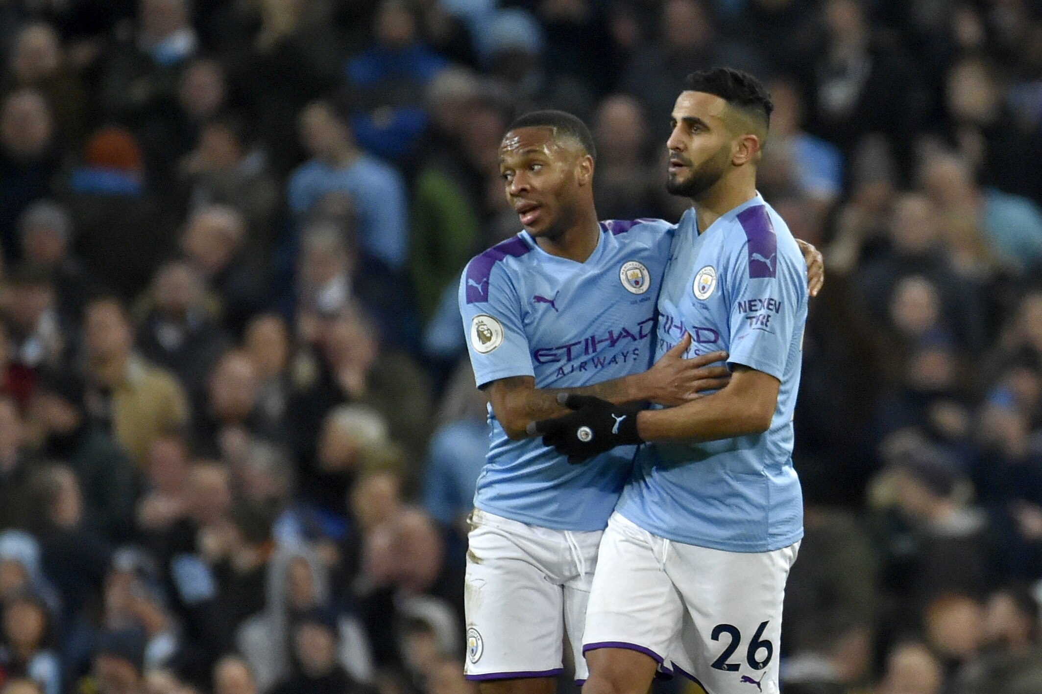 Manchester City's Riyad Mahrez, right, celebrates with Raheem Sterling after scoring his side's first goal during the English Premier League soccer match between Manchester City and Leicester City at Etihad stadium in Manchester, England, Saturday, Dec. 21, 2019. (AP Photo/Rui Vieira)