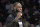 Los Angeles Lakers injured guard LeBron James cheers his team during the first half of an NBA basketball game against the Denver Nuggets on Sunday, Dec. 22, 2019, in Los Angeles. The Nuggets won 128-104. James sat out the game because of a thoracic muscle strain. (AP Photo/Michael Owen Baker)