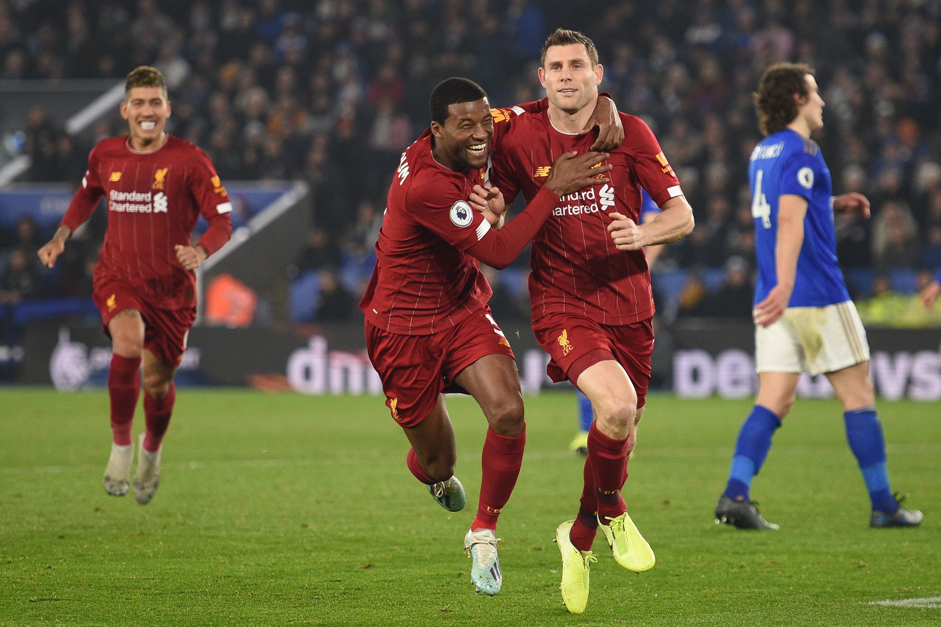 Liverpool's English midfielder James Milner (2nd R) celebrates with teammates after scoring their second goal from the penalty spot during the English Premier League football match between Leicester City and Liverpool at King Power Stadium in Leicester, central England on December 26, 2019. (Photo by Oli SCARFF / AFP) / RESTRICTED TO EDITORIAL USE. No use with unauthorized audio, video, data, fixture lists, club/league logos or 'live' services. Online in-match use limited to 120 images. An additional 40 images may be used in extra time. No video emulation. Social media in-match use limited to 120 images. An additional 40 images may be used in extra time. No use in betting publications, games or single club/league/player publications. / (Photo by OLI SCARFF/AFP via Getty Images)