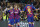 Barcelona's Lionel Messi, left, celebrates after scoring his side's second goal with Antoine Griezmann, centre and Luis Suarez during a Champions League soccer match Group F between Barcelona and Dortmund at the Camp Nou stadium in Barcelona, Spain, Wednesday, Nov. 27, 2019. (AP Photo/Joan Monfort)