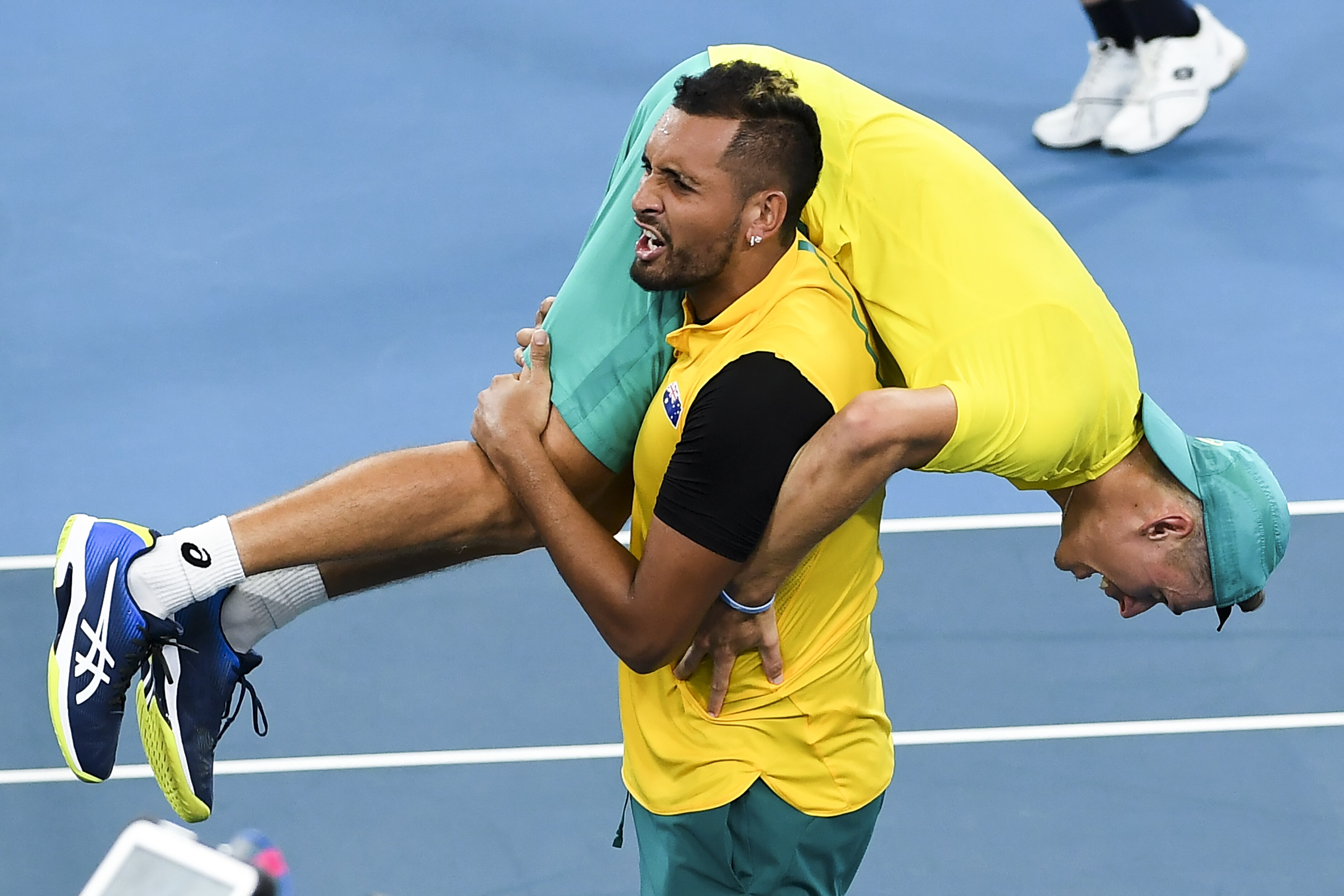 Nick Kyrgios of Australia carries teammate Alex de Minaur after winning their men's doubles match against Jamie Murray and Joe Salisbury of Britain at the ATP Cup tennis tournament in Sydney on January 9, 2020. (Photo by William WEST / AFP) / --IMAGE RESTRICTED TO EDITORIAL USE - NO COMMERCIAL USE-- (Photo by WILLIAM WEST/AFP via Getty Images)