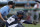 Home plate umpire Brian deBrauwere, left, huddles behind Freedom Division catcher James Skelton, of the York Revolution, as the official wears an earpiece during the first inning of the Atlantic League All-Star minor league baseball game, Wednesday, July 10, 2019, in York, Pa. deBrauwere wore the earpiece connected to an iPhone in his ball bag which relayed ball and strike calls upon receiving it from a TrackMan computer system that uses Doppler radar. The independent Atlantic League became the first American professional baseball league to let the computer call balls and strikes during the all star game. (AP Photo/Julio Cortez)