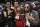 Rapper Quavo, center, the MVP of the NBA All-Star celebrity basketball game, holds his trophy as he poses with his Migos bandmates Offset, left, and Takeoff following the game Friday, Feb. 16, 2018, in Los Angeles. (AP Photo/Chris Pizzello)