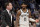 Brooklyn Nets guard Kyrie Irving (11) and head coach Kenny Atkinson, left, stand on the court in the first half of an NBA basketball game against the Memphis Grizzlies, Sunday, Oct. 27, 2019, in Memphis, Tenn. (AP Photo/Brandon Dill)
