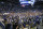 FILE - In this Feb. 22, 2020, file photo, BYU students and fans celebrate on the court following their victory over Gonzaga following an NCAA college basketball game, in Provo, Utah. Utah public health officials are contacting and testing BYU basketball fans who sat near a coronavirus patient at a game prior to the infection being diagnosed, the university said Monday, March 9, 2020. He had mild symptoms and there's little risk the virus was transmitted more widely the Feb. 22 game against Gonzaga, the school said in a statement. People who went to the game don't need to do anything unless the are contacted by the Utah County Health Department. (AP Photo/Rick Bowmer, File)