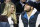 FILE - In this Nov. 17, 2015, file photo, Detroit Lions quarterback Matthew Stafford and his wife Kelly smile while watching the Detroit Pistons play the Cleveland Cavaliers during an NBA basketball game, in Auburn Hills, Mich. Matthew is juggling his job on the field and his role as a husband and father as his wife, Kelly, recovers from surgery to remove a brain tumor. (AP Photo/Duane Burleson, File)
