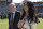 FILE - In this Jan. 7, 2018, file photo, Buffalo Bills owners Terry and Kim Pegula walk on the sideline before an NFL wild-card playoff football game against the Jacksonville Jaguars in Jacksonville, Fla. Pegula Sports and Entertainment, the parent company that owns the NFL Buffalo Bills and NHL Sabres is experiencing a major shake-up following the departures of three top executives.  PSE CEO and president Kim Pegula says the changes come after she had been