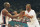 Magic Johnson greets teammate Michael Jordan as Jordan takes the bench during a U.S. game in the Basketball Tourney of the Americas game in Portland on July 12, 1992. Johnson, who withdrew from competition in the NBA earlier after testing positive for the HIV virus, is playing the game with all of the skill and heart he showed in the NBA. (AP Photo/Jack Smith)