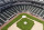 In an otherwise empty ballpark, grounds crew members continue to keep the Seattle Mariners' field in playing shape as the ballpark goes into its seventh week without baseball played because of the coronavirus outbreak, Monday, May 11, 2020, in Seattle. A person familiar with the decision tells The Associated Press that Major League Baseball owners have given the go-ahead to making a proposal to the players' union that could lead to the coronavirus-delayed season starting around the Fourth of July weekend in ballparks without fans. (AP Photo/Elaine Thompson)
