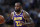 Los Angeles Lakers forward LeBron James brings the ball up during the first half of the team's NBA basketball game against the Denver Nuggets on Wednesday, Feb. 12, 2020, in Denver. (AP Photo/David Zalubowski)