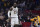 Los Angeles Lakers forward LeBron James walks away from a fan that is reading out to him during the first half of an NBA basketball game against the Los Angeles Clippers Sunday, March 8, 2020, in Los Angeles. (AP Photo/Mark J. Terrill)
