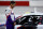 DARLINGTON, SOUTH CAROLINA - MAY 20: Denny Hamlin, driver of the #11 FedEx Delivering Strength Toyota, stands on the grid during the national anthem prior to the NASCAR Cup Series Toyota 500 at Darlington Raceway on May 20, 2020 in Darlington, South Carolina. (Photo by Chris Graythen/Getty Images)
