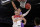 LaMelo Ball of the Illawarra Hawks, left, lays up around Andrew Bogut of the Sydney Kings during their game in the Australian Basketball League in Sydney, Sunday, Nov. 17, 2019. (AP Photo/Rick Rycroft)