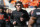 FILE - In this Nov. 2, 2019, file photo, Oklahoma State coach Mike Gundy runs onto the field before the team's NCAA college football game against TCU in Stillwater, Okla. Hubbard said on Twitter that he wonâ€™t do anything with the program until there is change after Gundy was photographed wearing a T-shirt representing far-right online publication One America News Network. Gundy is seen in a photograph on Twitter wearing the T-shirt with the letters OAN. (AP Photo/Sue Ogrocki, File)
