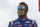 Bubba Wallace walks down pit row down before the start of a scheduled NASCAR Cup Series auto race at Pocono Raceway, Saturday, June 27, 2020, in Long Pond, Pa. (AP Photo/Matt Slocum)