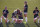 Chicago Red Stars' Julie Ertz, second from left, holds Casey Short, center, while other players for the team kneel during the national anthem before an NWSL Challenge Cup soccer match against the Washington Spirit at Zions Bank Stadium, Saturday, June 27, 2020, in Herriman, Utah. (AP Photo/Rick Bowmer)