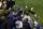 FILE - In this Oct 14, 2003, file photo, Steve Bartman, top center, catches a ball as Chicago Cubs left fielder Moises Alou's arm is seen reaching into the stands, at right, against the Florida Marlins in the eighth inning during Game 6 of the National League championship series Tuesday, Oct. 14, 2003, at Wrigley Field in Chicago. The Cubs announced Monday, July 31, 2017, they were giving a 2016 World Series championship ring to Bartman, the fan remembered for deflecting a foul ball that appeared destined to land in left fielder Moises Alou's glove with Chicago five outs from the World Series in 2003. (AP Photo/Morry Gash, File)