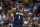 FILE - In this March 6, 2020, file photo, New Orleans Pelicans forward Zion Williamson walks onto the court during the second half of the team's NBA basketball game against the Miami Heat in New Orleans. The rookie sensation’s availability to play remained unclear as the season’s resumption in Lake Buena Vista, Florida, approached. He left the NBA’s so-called “bubble” setup on July 16 to attend to an unspecified family medical matter. A week later, the club had yet to provide an update on his possible return.  (AP Photo/Rusty Costanza, File)