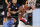 Portland Trail Blazers' Damian Lillard, right, shoots past Memphis Grizzlies' Jonas Valanciunas during the first half of an NBA basketball game Friday, July 31, 2020, in Lake Buena Vista, Fla. (Mike Ehrmann/Pool Photo via AP)