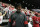 Washington State football head coach Nick Rolovich walks along the court before an NCAA college basketball game between Washington State and Oregon State in Pullman, Wash., Saturday, Jan. 18, 2020. (AP Photo/Young Kwak)