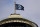 A flag with the new logo for the newly-named Seattle NHL team, the Seattle Kraken, flies atop the iconic Space Needle Thursday, July 23, 2020, in Seattle. The hockey expansion franchise unveiled its nickname Thursday, ending 19 months of speculation about whether the team might lean traditional or go eccentric with the name for the league's 32nd team. Seattle's colors are a deep dark blue with a lighter shade of blue as a complement. (AP Photo/Elaine Thompson)