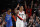 Portland Trail Blazers guard Damian Lillard, right, reacts after making a basket as Oklahoma City Thunder forward Paul George, left, trails the play during the first half of Game 1 of a first-round NBA basketball playoff series in Portland, Ore., Sunday, April 14, 2019. (AP Photo/Steve Dipaola)
