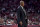 Kentucky associate head coach Kenny Payne watches from the sideline after head coach John Calipari was ejected from an NCAA collage basketball game against Arkansas during the second half Saturday, Jan. 18, 2020, in Fayetteville, Ark. (AP Photo/Michael Woods)