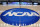 FILE - In this March 18, 2015, file photo, the NCAA logo is displayed at center court as work continues at The Consol Energy Center in Pittsburgh, for the NCAA college basketball tournament. The NCAA took a significant step toward allowing all Division I athletes to transfer one time without sitting out a season of competition. A plan to change the waiver process is expected to be presented to the Division I Council in April, 2020. If adopted, new criteria would go into effect for the 2020-21 academic year and be a boon for athletes in high-profile sports such as football and men's and women's basketball. (AP Photo/Keith Srakocic, File)