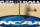 FILE - In this March 14, 2012, file photo, a player runs across the NCAA logo during practice at the NCAA tournament college basketball in Pittsburgh. The NCAA is on its heels again, playing defense of its archaic amateurism rules after missing an opportunity to get out in front of an issue.  (AP Photo/Keith Srakocic, File)