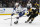 Tampa Bay Lightning's Anthony Cirelli, left, shoots while being checked by Boston Bruins' Charlie Coyle during the third period of an NHL hockey game Saturday, March 7, 2020, in Boston. (AP Photo/Winslow Townson)