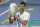 Novak Djokovic, of Serbia, front, holds his winning trophy after winning his match with Milos Raonic, of Canada, at the Western & Southern Open tennis tournament Saturday, Aug. 29, 2020, in New York. (AP Photo/Frank Franklin II)