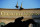 FILE - In this May 6, 2020 file photo a statue of Barbaro is silhouetted at the entrance of Churchill Downs in Louisville, Ky. Horse racing is in a state of transition at a time usually reserved for Triple Crown season. The Preakness would have been run Saturday, May 16, 2020 in Baltimore. But Pimlico Race Course and many tracks across North America remain dark because of the coronavirus pandemic. There is some light at the end of the tunnel as tracks including Churchill Downs in Kentucky are getting back to live racing without fans.  (AP Photo/Darron Cummings, file)