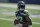 Seattle Seahawks running back Chris Carson holds the football as players warm up for an NFL football scrimmage Wednesday, Aug. 26, 2020, in Seattle. (AP Photo/Ted S. Warren)