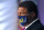 Ed Orgeron, head coach of the NCAA national champion LSU football team, wears a mask as he listens to Vice President Mike Pence speak at a roundtable discussion at Tiger Stadium on the LSU campus in Baton Rouge, La., Tuesday, July 14, 2020. (AP Photo/Gerald Herbert)