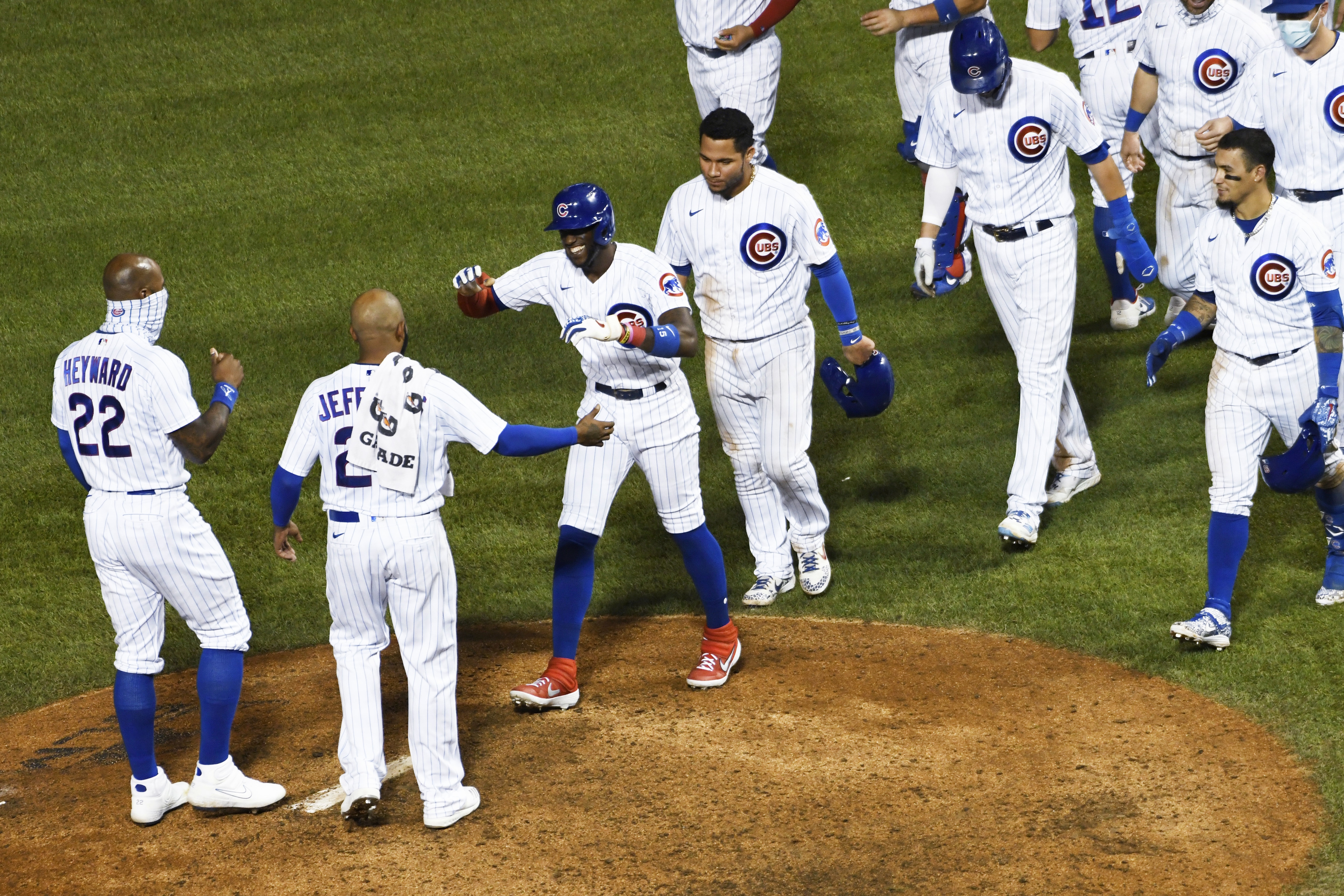 Chicago Cubs' Cameron Maybin, third from left, smiles after walking with the bases loaded to drive in the winning run against the Cleveland Indians in a baseball game Tuesday, Sept. 15, 2020, in Chicago. (AP Photo/David Banks)