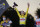 Tour de France winner Tadej Pogacar, wearing the overall leader's yellow jersey, second placed Primoz Roglic of Slovenia, left, and third placed Richie Porte of Australia, celebrate on the podium after the twenty-first and last stage of the Tour de France cycling race over 122 kilometers (75.8 miles), from Mantes-la-Jolie to Paris, France, Sunday, Sept. 20, 2020. (AP Photo/Christophe Ena)