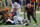 Dallas Cowboys running back Ezekiel Elliott, bottom center, fumbles the ball as Cleveland Browns' Andrew Sendejo (23), Vincent Taylor (96) and others race after the loose ball in the first half of an NFL football game in Arlington, Texas, Sunday, Oct. 4, 2020. The Browns recovered the ball. (AP Photo/Ron Jenkins)