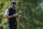 Dustin Johnson, of the United States, checks his notes on the fifth green during the third round of the US Open Golf Championship, Saturday, Sept. 19, 2020, in Mamaroneck, N.Y. (AP Photo/John Minchillo)