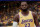 FILE - In this Feb. 21, 2020, file photo, Los Angeles Lakers forward LeBron James, left, stands with forward Anthony Davis during the second half of an NBA basketball game against the Memphis Grizzlies in Los Angeles. James and Davis had the Lakers on course to contend for another NBA title before the coronavirus pandemic upended their first season together. The superstars see no reason they can’t continue their quest in Orlando, and Davis even thinks the Lakers’ chances have improved.(AP Photo/Mark J. Terrill, File)