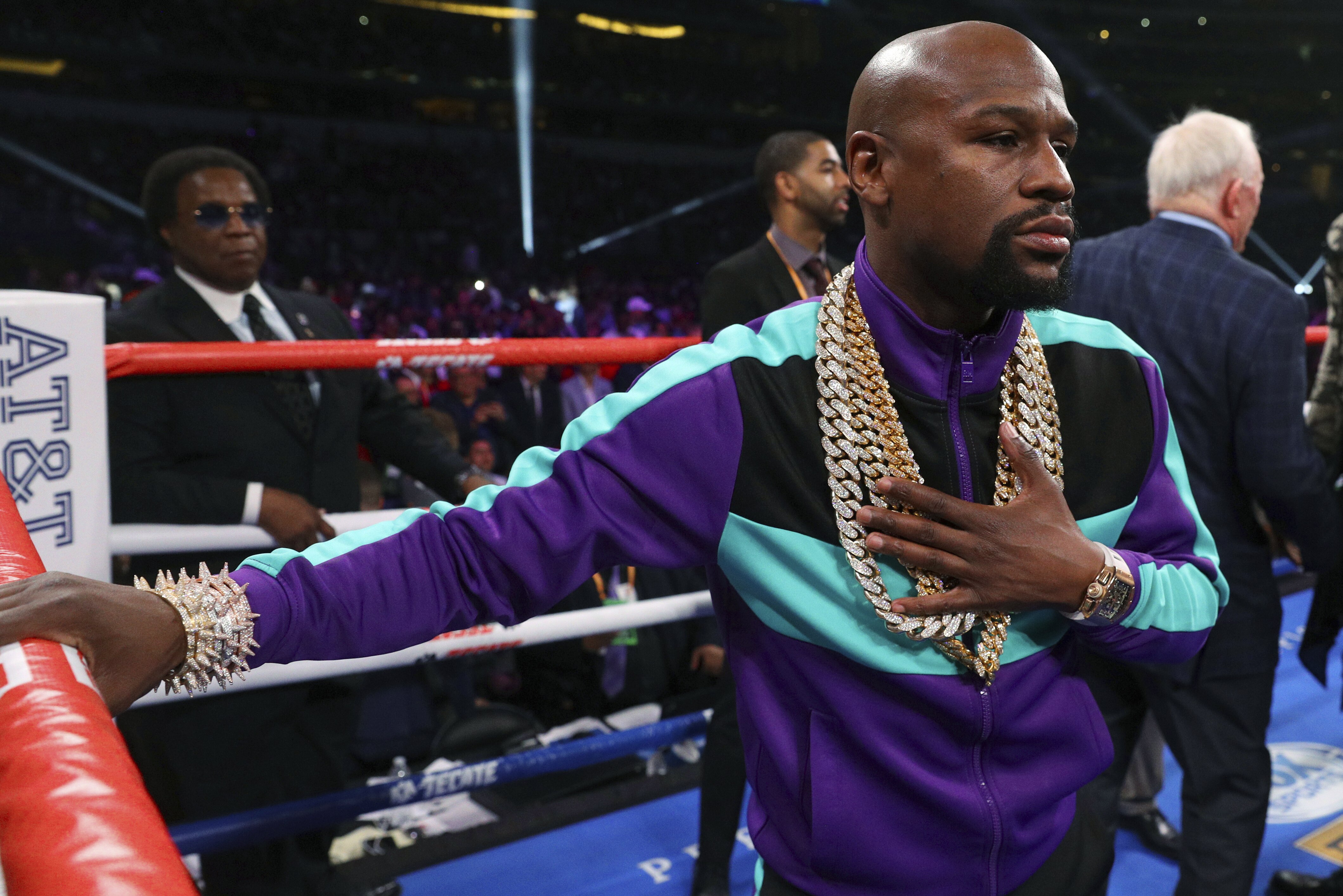 Floyd Mayweather stands in the ring before the IBF welterweight championship bout between Errol Spence Jr. and Mikey Garcia on Saturday, March 16, 2019, in Arlington, Texas. (AP Photo/Richard W. Rodriguez)