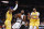 Los Angeles Clippers' Kawhi Leonard (2) looks to pass the ball against Los Angeles Lakers' LeBron James (23) and Los Angeles Lakers' Anthony Davis (3) during an NBA basketball game between Los Angeles Lakers and Los Angeles Clippers, Wednesday, Dec. 25, 2019, in Los Angeles. The Clippers won 111-106. (AP Photo/Ringo H.W. Chiu)