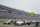 Cars sit on pit road during a red flag period due to mist during a NASCAR Cup Series auto race at Texas Motor Speedway in Fort Worth, Texas, Sunday, Oct. 25, 2020. (AP Photo/Richard W. Rodriguez)