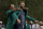 Tiger Woods helps Masters' champion Dustin Johnson with his green jacket after his victory at the Masters golf tournament Sunday, Nov. 15, 2020, in Augusta, Ga. (AP Photo/Charlie Riedel)