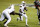 Miami quarterback D'Eriq King (1) runs past North Carolina State linebacker Isaiah Moore, obscured at left, during the first half of an NCAA college football game Friday, Nov. 6, 2020, in Raleigh, N.C. (Ethan Hyman/The News & Observer via AP, Pool)