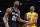 Los Angeles Lakers' Kobe Bryant (24) and San Antonio Spurs' Tim Duncan (21) watch a shot by Duncan in the first half of an NBA basketball game in Los Angeles, Tuesday, Nov. 13, 2012. (AP Photo/Jae C. Hong)
